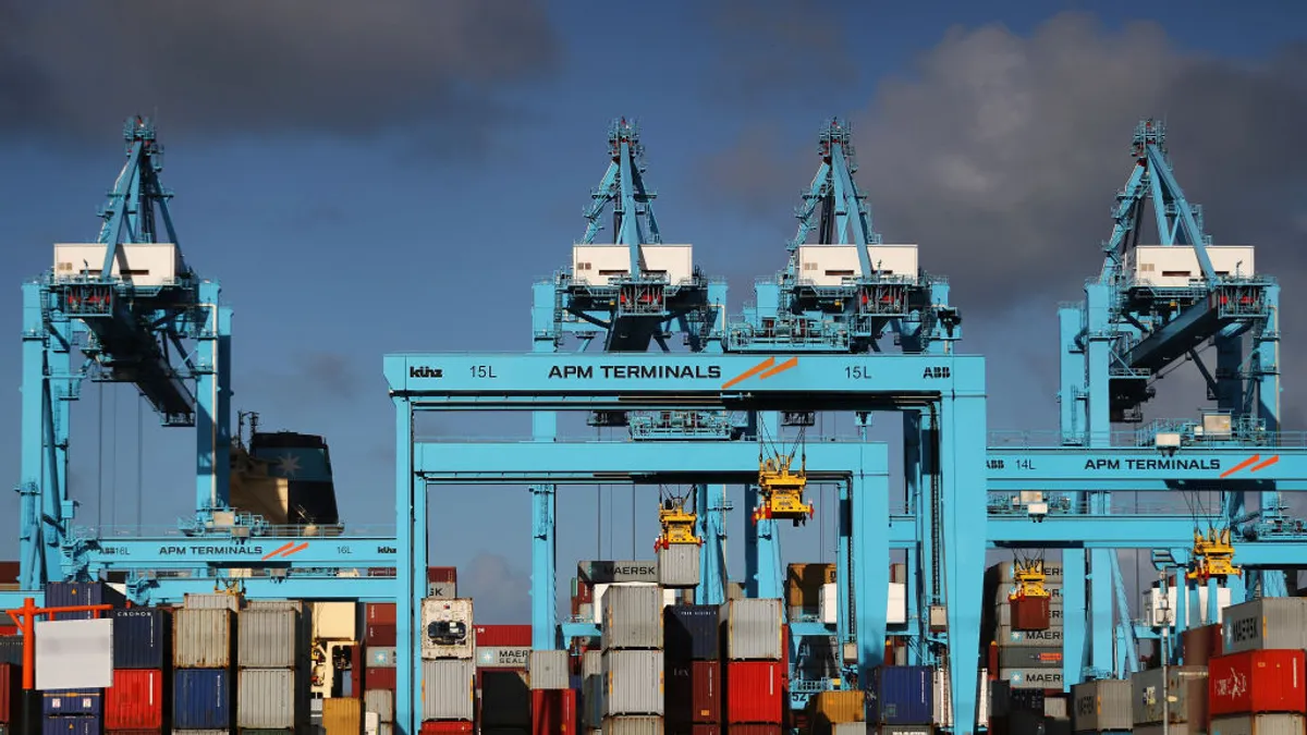 A general view of shipping containers and cranes at an ocean port.