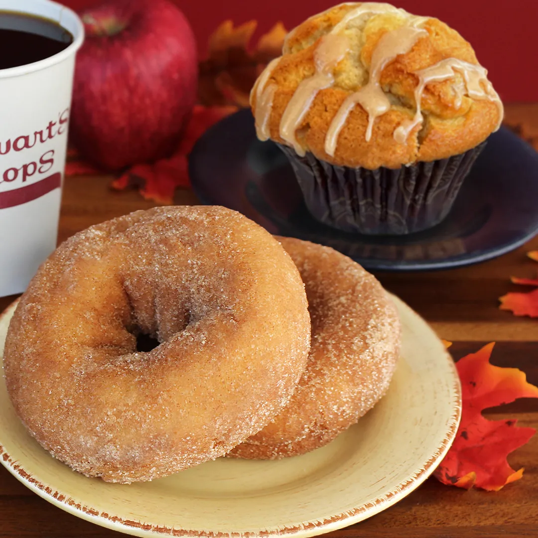 A photo of a donut and a muffin on a table.