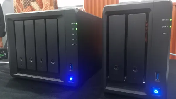 Two network attach computer servers are pictured in an office.