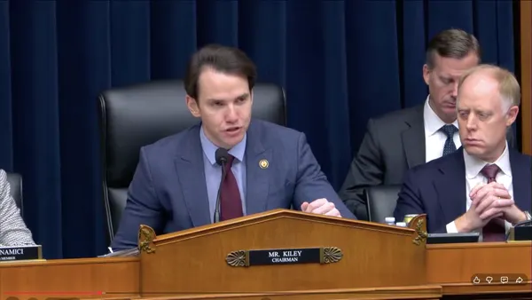 Rep. Kevin Kiley speaks into a microphone behind a podium in Congress