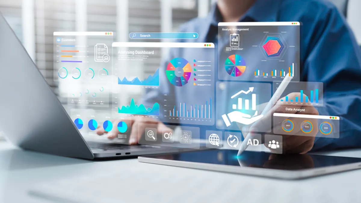 Person interacting with a holographic dashboard displaying charts and analytics.