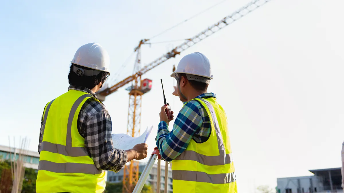 Construction engineers discussion with architects at construction site