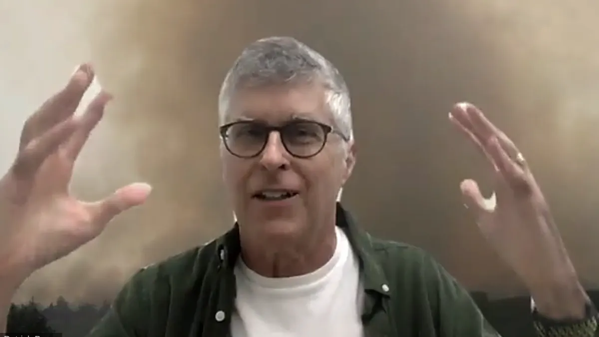 Impossible Foods founder and CEO Pat Brown speaks with a Zoom background of fires in the Amazon rainforest at an October 2020 press conference.