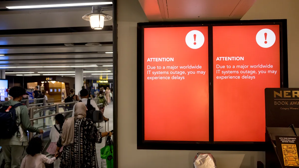 A screen showing a technical error message in an airport hallway