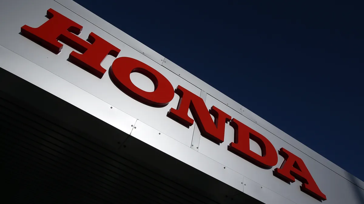 Honda's sign appears on the outside of a building.