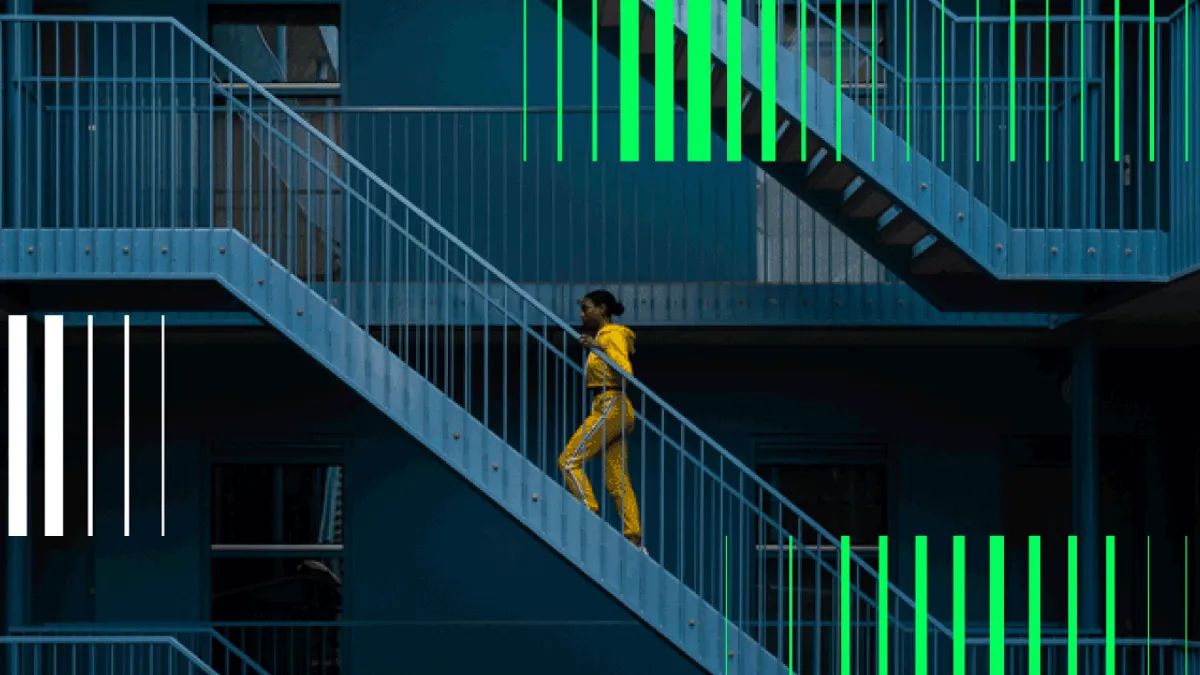 Woman Walking On Staircase Of Building