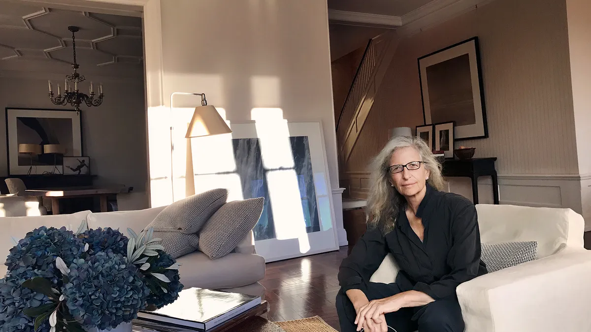 Photographer Annie Leibovitz sitting