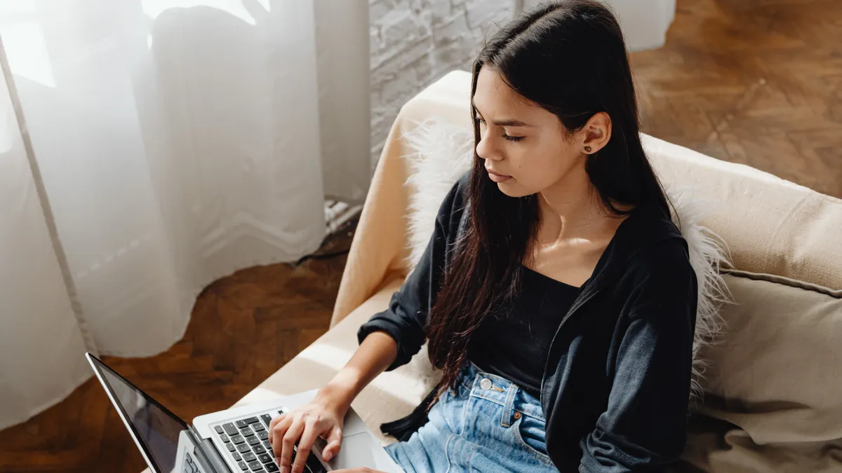 High angle shot of a Latinx person using a laptop