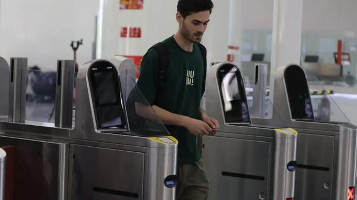 A person passes through an automated turnstile in China.