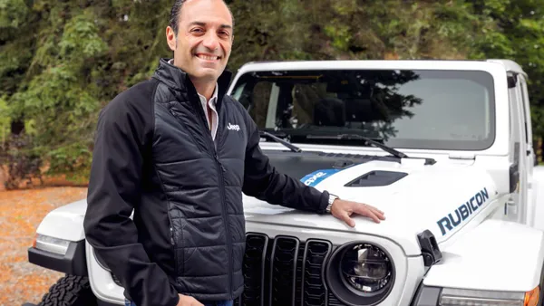 A man standing next to a Jeep