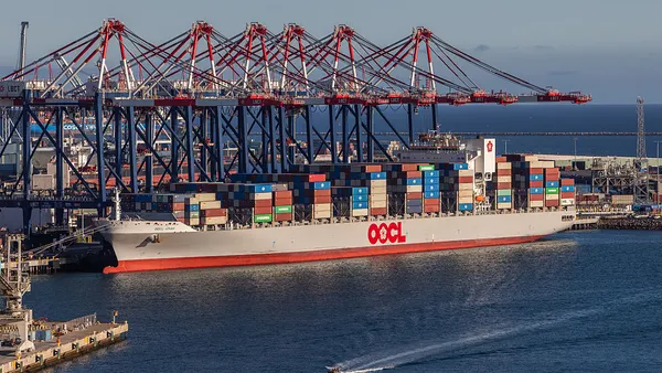 An ocean vessel docked at a seaport.