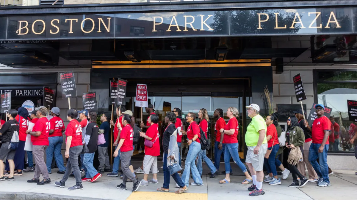 Workers hold picket signs outside the Hilton Boston Park Plaza.