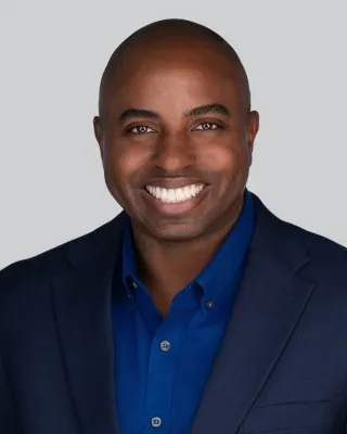 Headshot of a man in a suit.