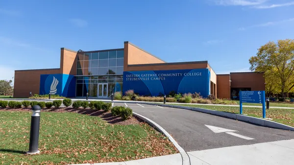 A brick-and-glass building is wrapped in a blue sign reading "Eastern Gateway Community College Steubenville Campus."