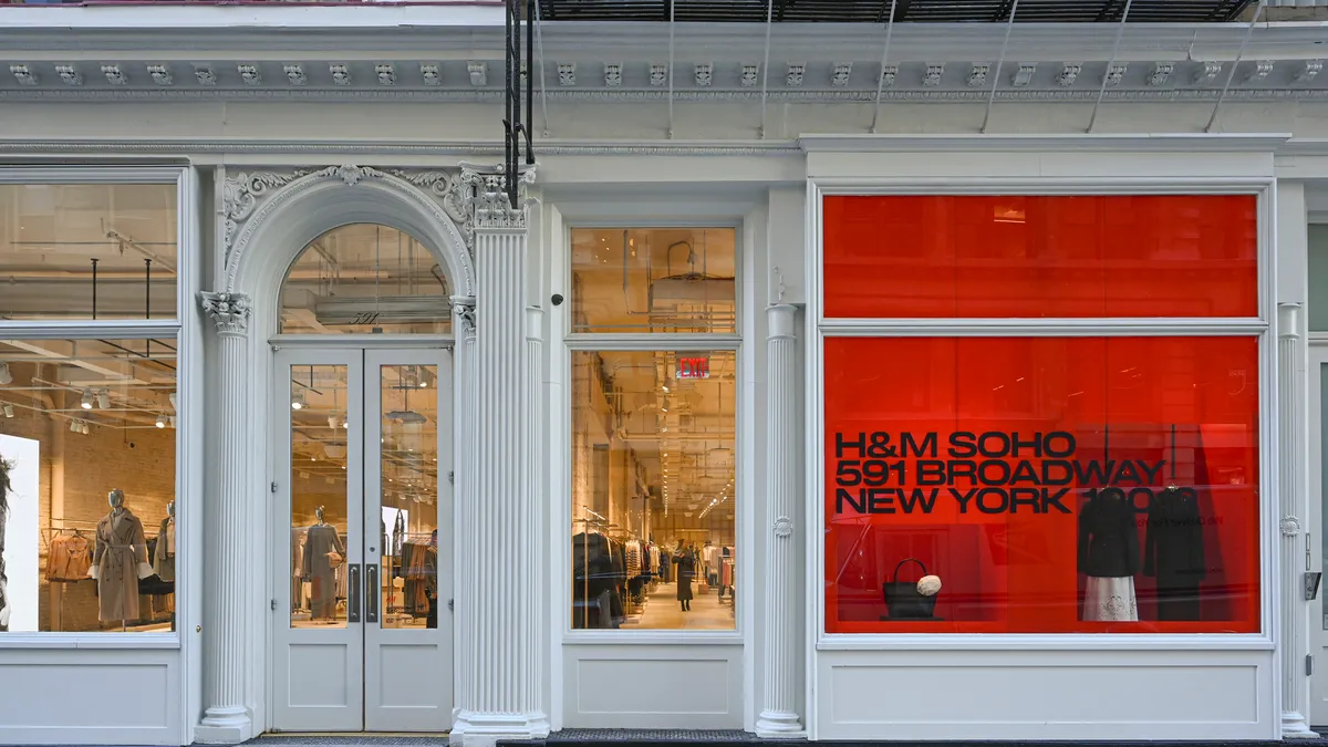 A white storefront with a red window display at H&M's SoHo store.