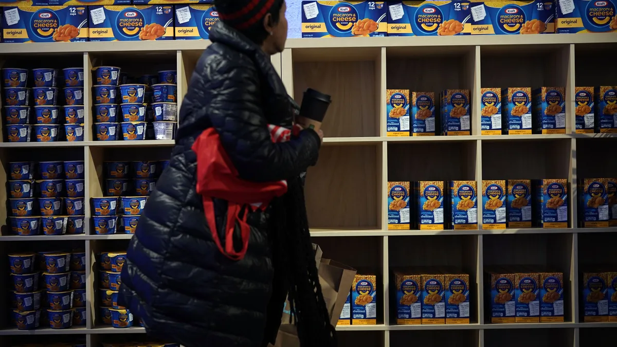 A customer picks up food at a pop-up store of Kraft Heinz.