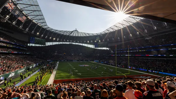 A stadium full of fans watching football.