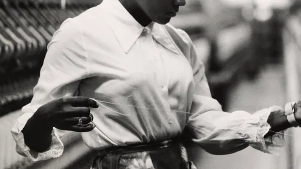 A Black woman works on a loom in a textile mill, North Carolina, circa 1960.