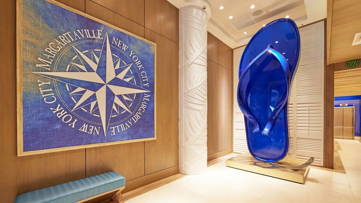 A large blue glass flip flop is in the entryway to Margaritaville Times Square.