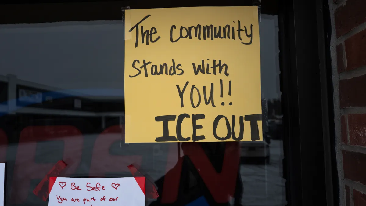 Messages opposing harsh immigration measures on a restaurant's door.