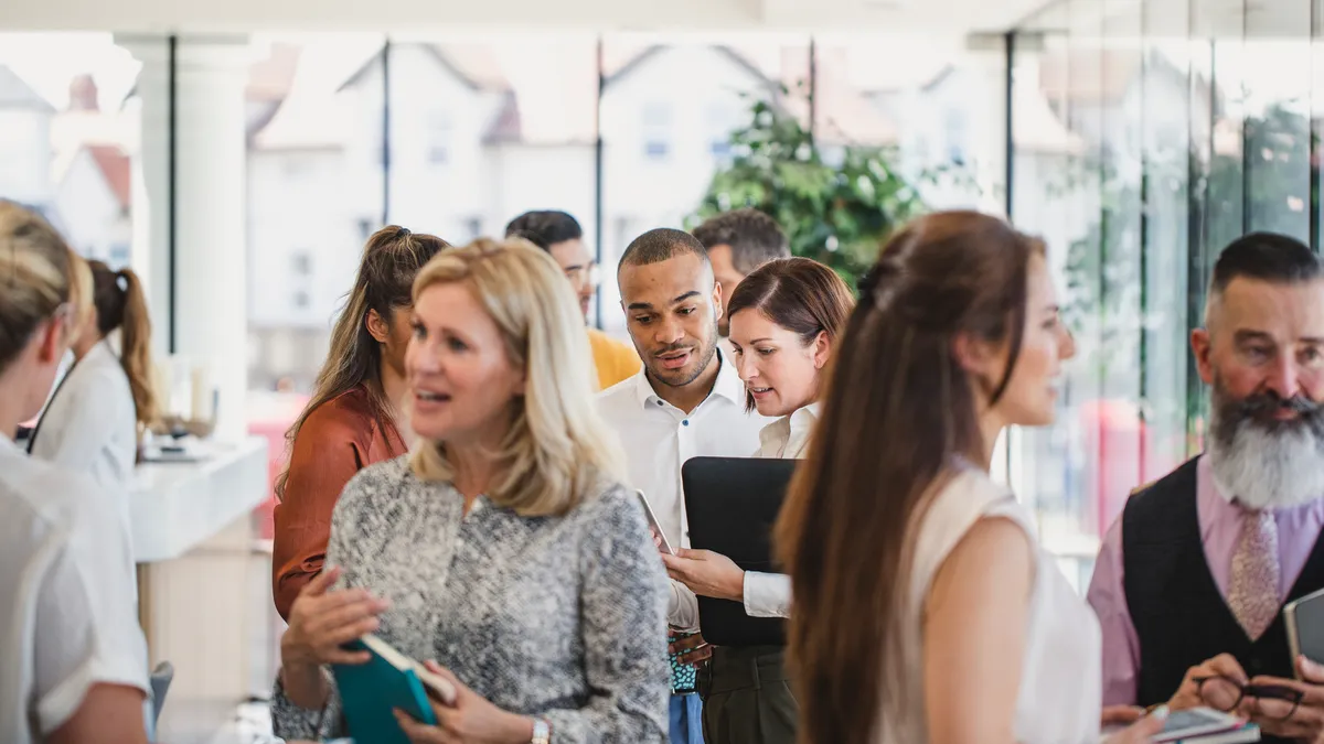 Business professionals attending business conference and networking.