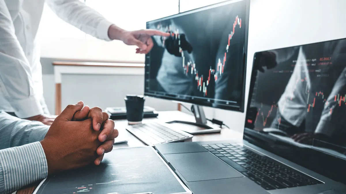 two people analyzing data on the computer