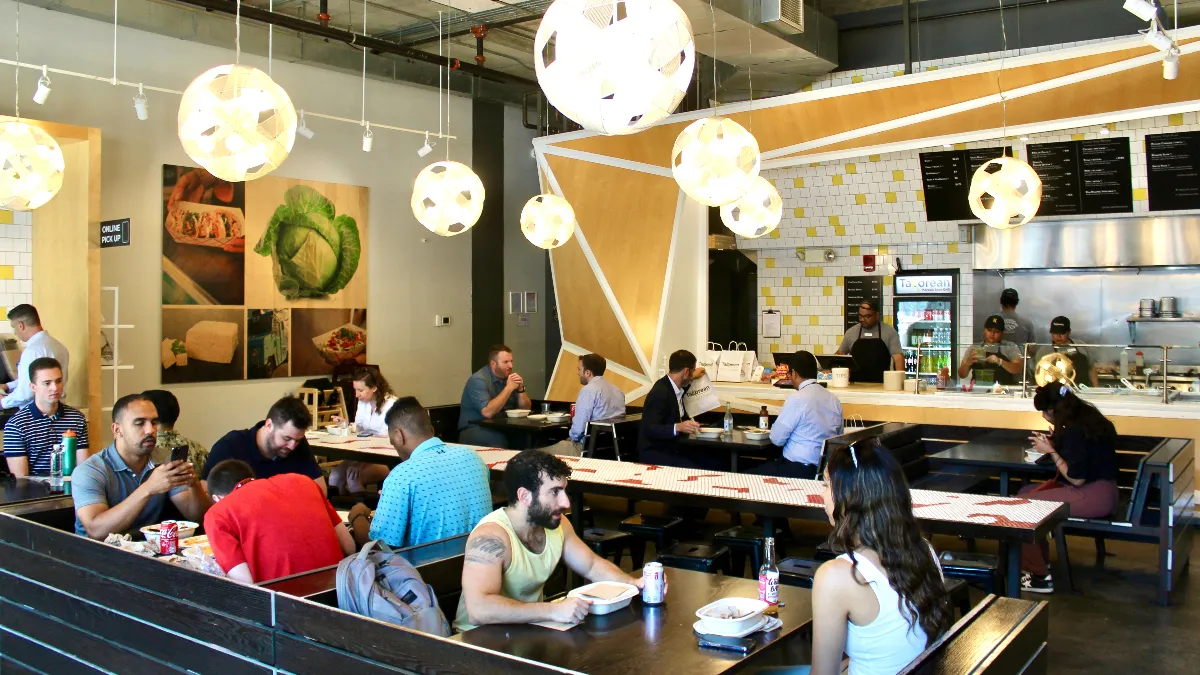 An image of customers sitting inside a restaurant.