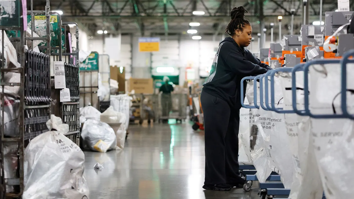 An employee works in a mail processing center.