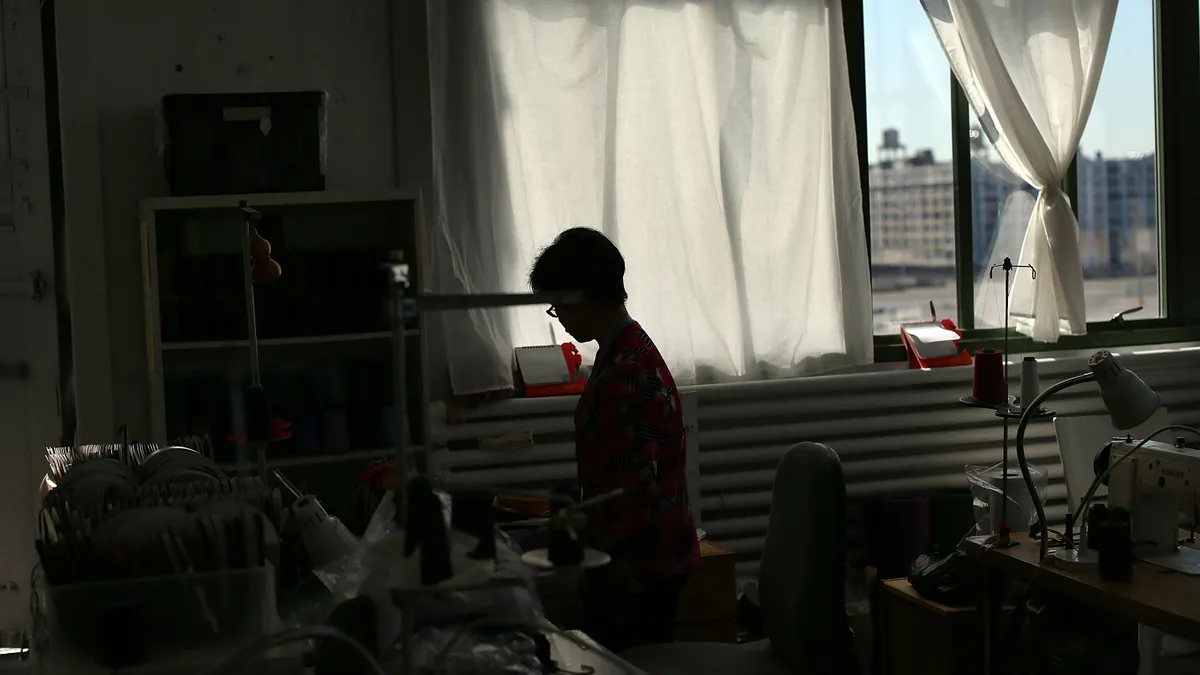 A pattern maker works in the loft of a Brooklyn garment manufacturer.