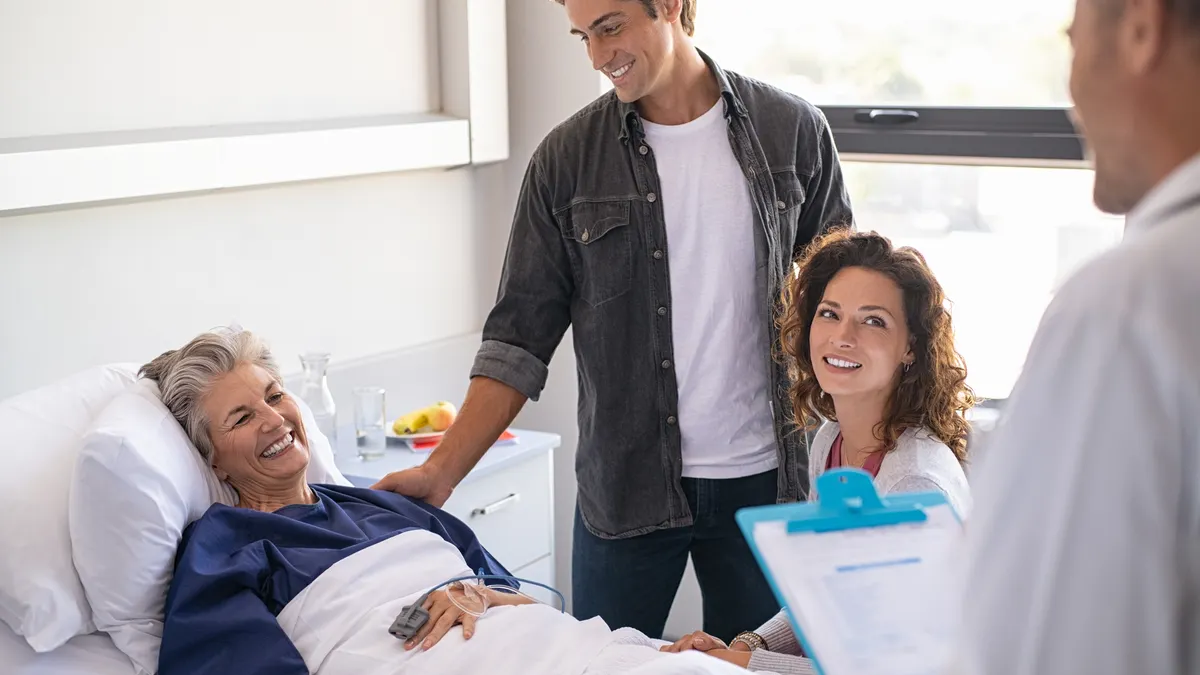 A family and a doctor standing around a hospital bed waiting for results from the doctor