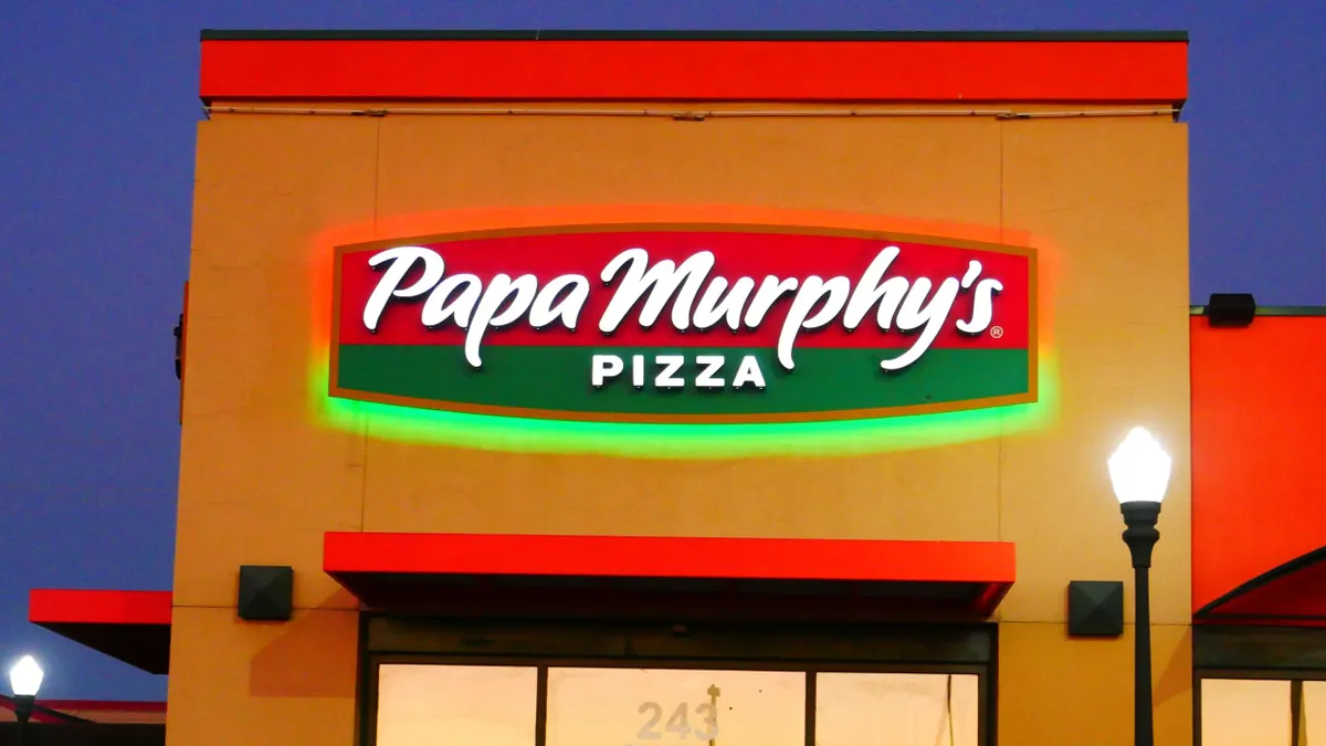 An evening image of a building that says Papa Murphy's