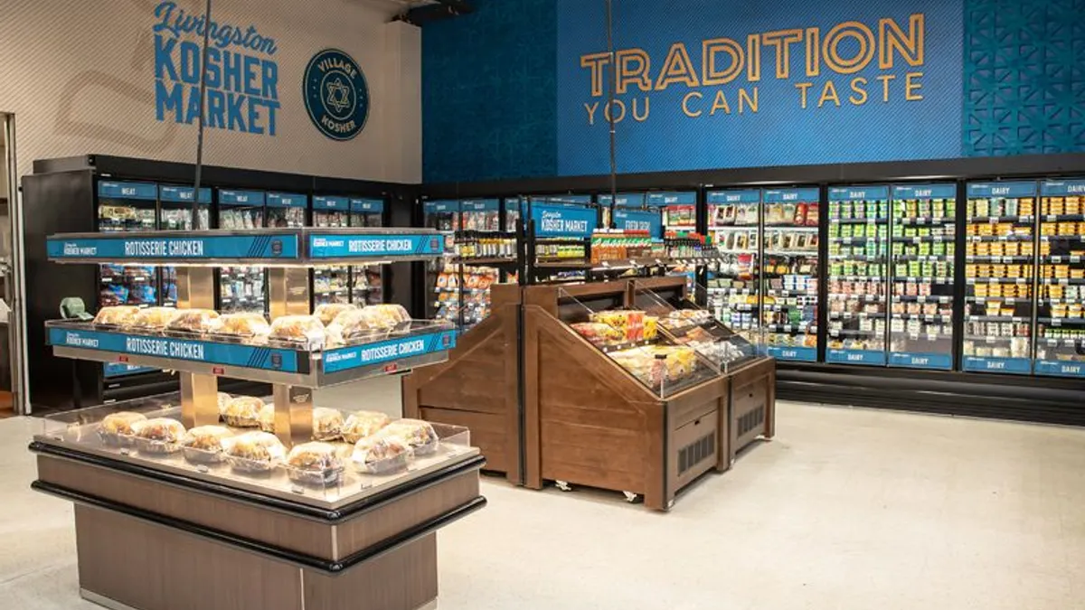 Interior of a grocery store with signs that read "Livingston Kosher Market" and "Tradition You Can Taste"