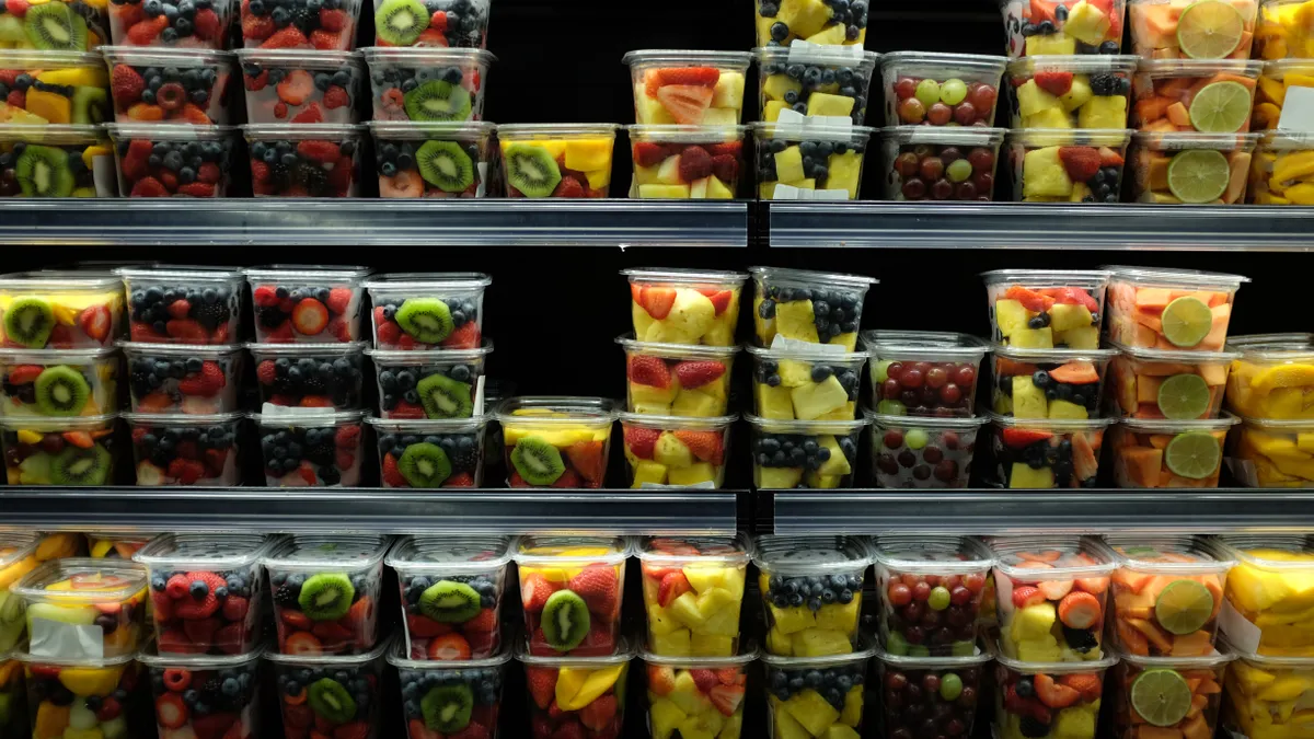 Cut fruit in plastic packaging on store shelves