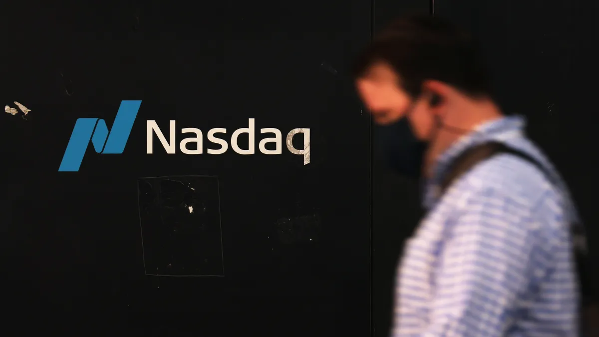 People walk past the Nasdaq MarketSite on October 12, 2022 in New York City.