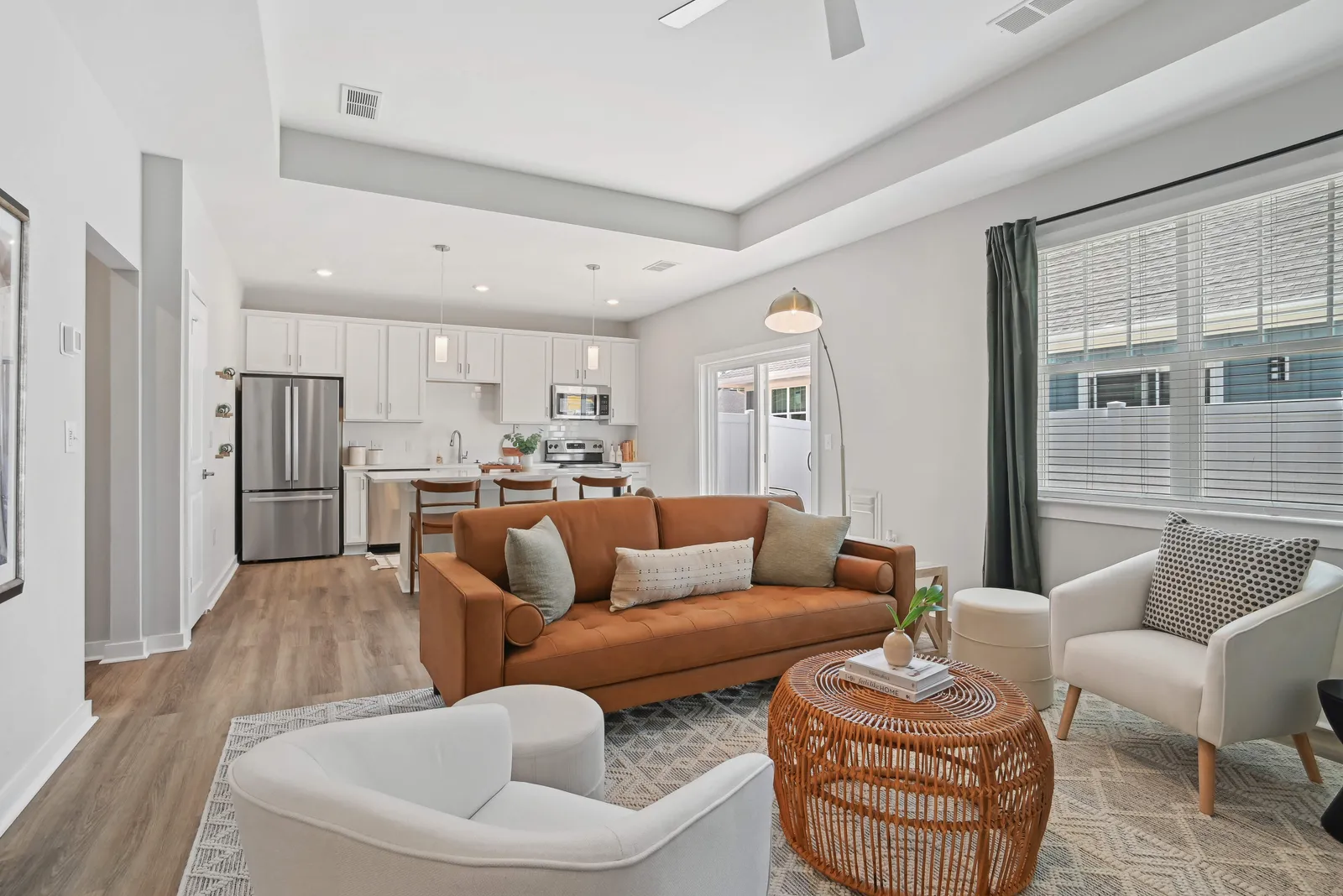 A living room with the kitchen visible in the back.