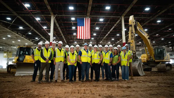 GE Appliances employees stand in manufacturing plant