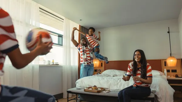 An image shows a family in a hotel room.