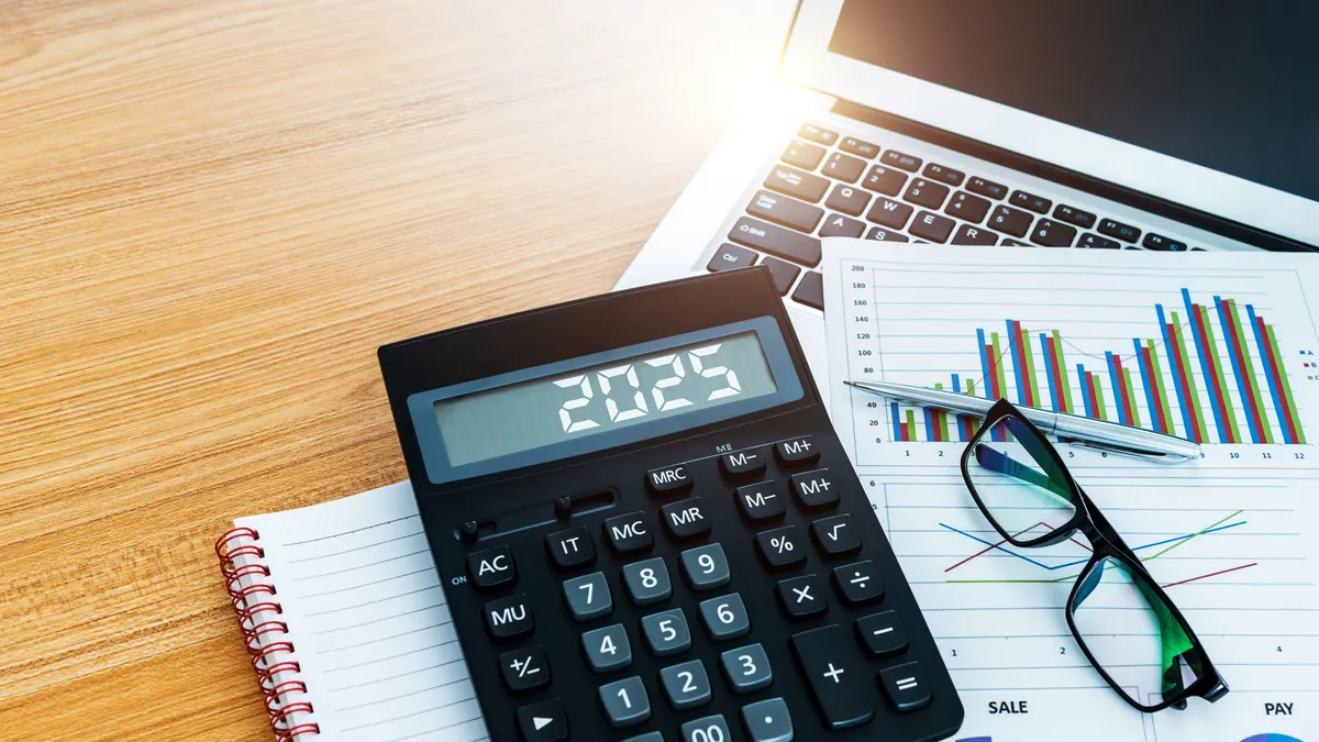 2025 on the calculator screen, at financial analysis desk