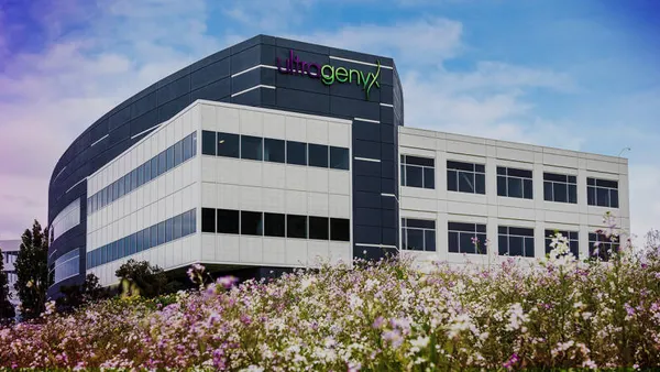 An Ultragenyx sign is seen on the side of an office building.