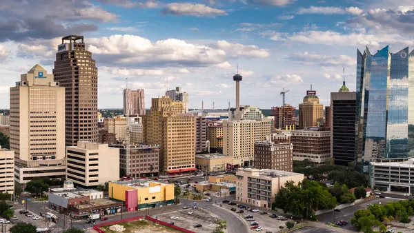 A sunny San Antonio, Texas skyline with several very tall buildings in frame.