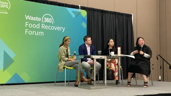 Four people sit on a small stage in front of a banner with the "Waste 360 - Waste Expo" logo and the words "Food Recovery Forum"