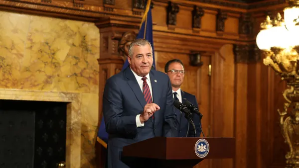 A man stands at a podium.
