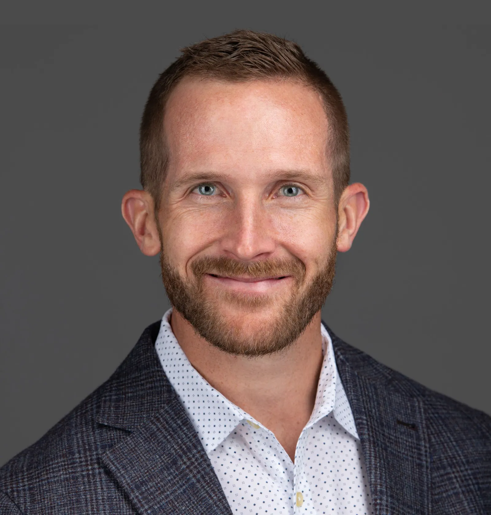 A headshot of a man in business attire.
