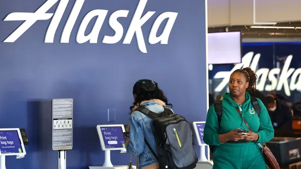 People check in at an Alaska kiosk.