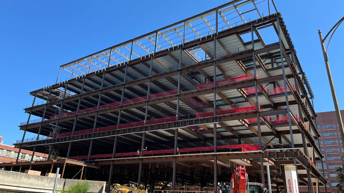 The exterior of a building under construction with its full steel frame assembled.