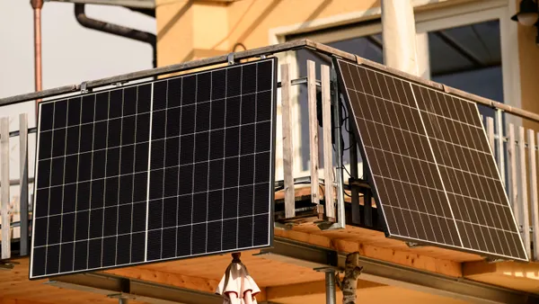 Solar panels hang from a balcony in Riegsee, Germany.