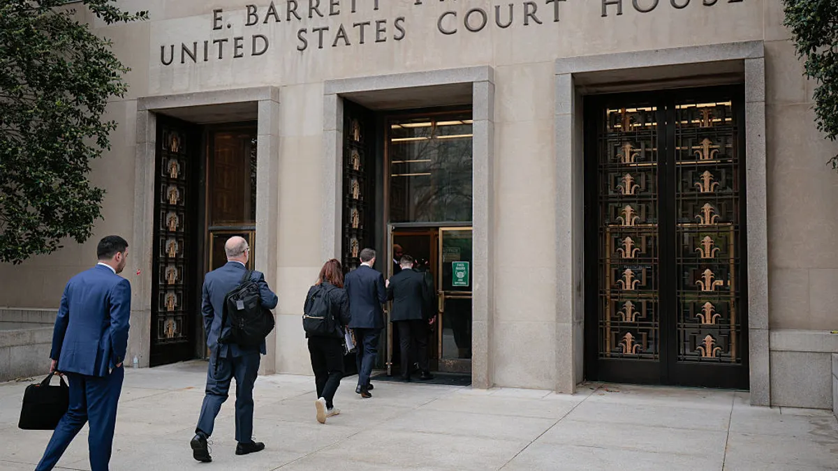 People walking into a building.