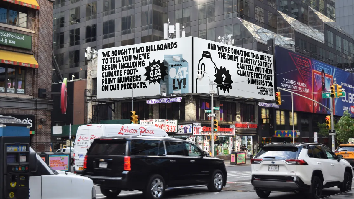 A billboard in Times Square for Oatly's new sustainability campaign challenging Big Dairy to reveal its carbon footprint.