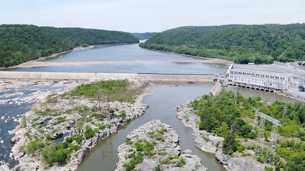 An aerial view of a hydroelectric dam on a river.