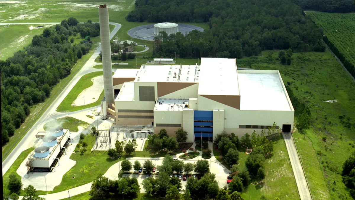 Aerial view of an industrial building with smoke stack